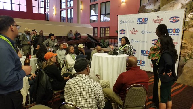 Black people and people of color gather to discuss the hemp industry in the hotel atrium.