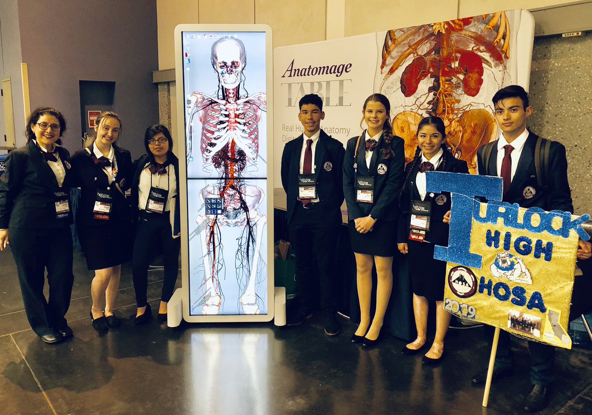 AnatomageTable's tweet image. Turlock HS #HOSA members at #calhosa SLC having fun with the #anatomagetable @Anatomage