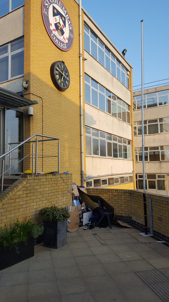StColumbasSHAPE's tweet photo. 150 students at the homeless sleepout, our biggest yet. They found shelter in all sorts of places. Here's a few Form 4 s on the patio at 6.30 this morning. https://t.co/yVMhJ8zO1M