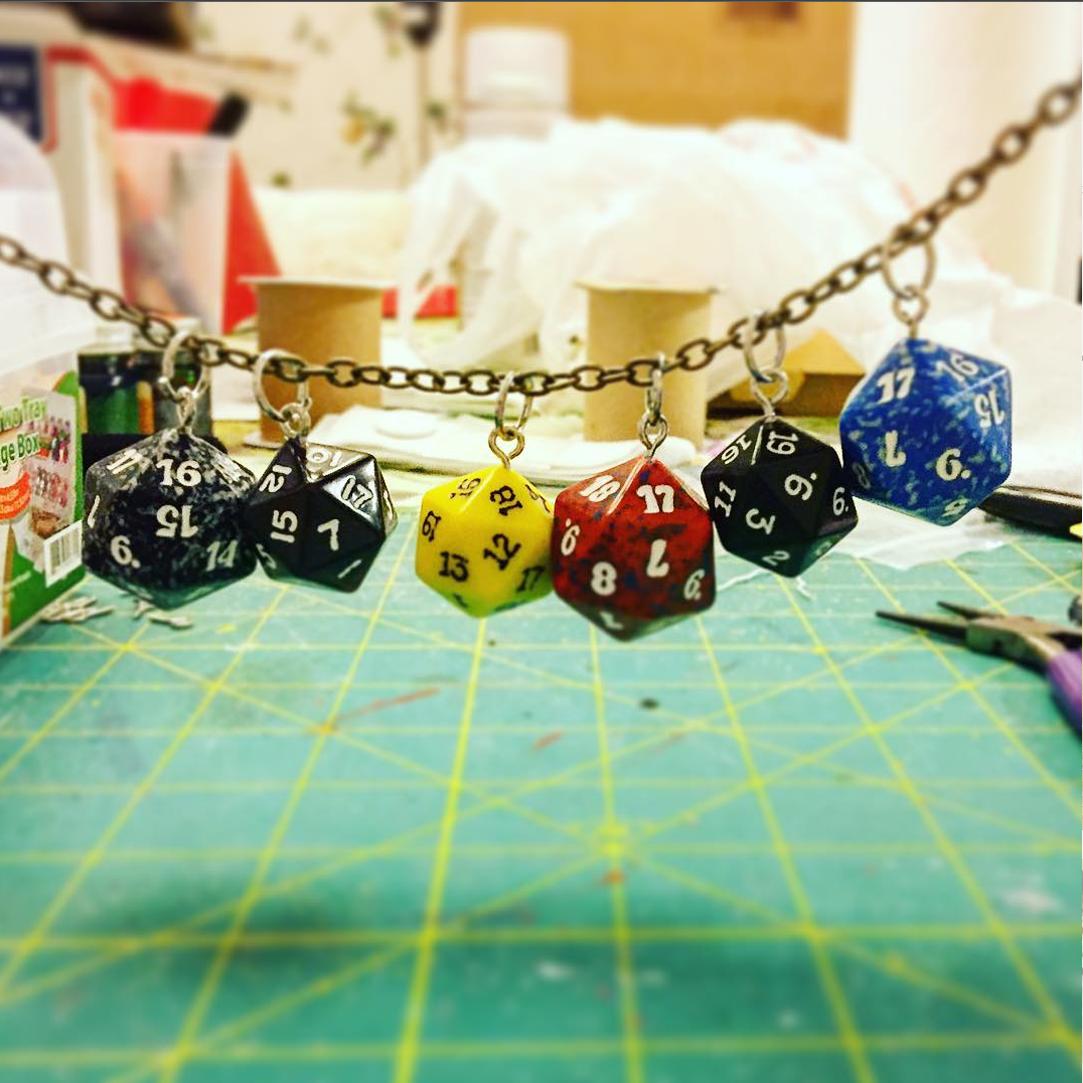 SkyfluArts's tweet photo. Figured out how to turn dice into charms~ prepare yourself. I have 100 D20s to work with. So many pretty colors. 
#d20roll #D20 #nerdlife https://t.co/aqA8BUCVNK