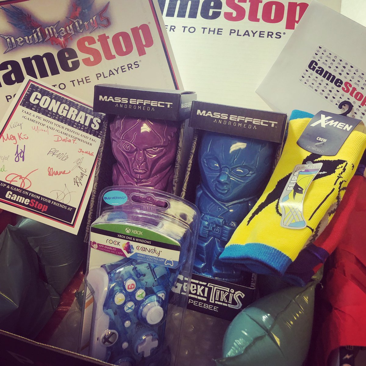 Justimajenn's tweet photo. @MelonieMac, look what @GameStop sent me! I thought I only won the controller on the DMC5 stream but they sent me that plus a bunch of goodies!!! #GameStopWinner https://t.co/DTJqGk9mDG