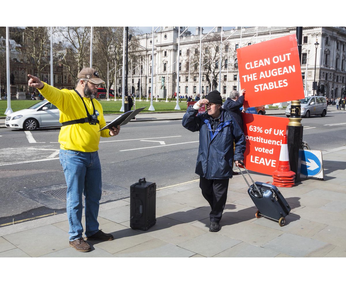 NicholasCobb11's tweet photo. The #voteleave chap in the dark hat asked the #preacher [in yellow] what he was going on about. He pointed at the statue of #olivercromwell and said "Him". #brexitsbarmy #MakeItStop The preacher fell silent as the Yellow Vests walked by... https://t.co/emjeovxECx