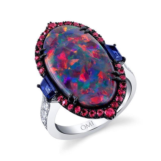 bijouxreview's tweet photo. The Southern California high jewelry brand Omi Privé @omiprive dramatizes a magically colored opal by flanking it with two trapezoid-shaped blue sapphires, 30 round, radiantly red spinels and 16 round brilliant diamonds. This one-of-a-kind ring is an art… https://t.co/C1WwyloDXk https://t.co/t7KVUDGYM1