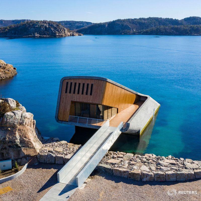 Reuters's tweet photo. Going 'Under': Europe’s first underwater restaurant opens in Norway on Wednesday with more than 7,000 customers booked in to eat among the fish https://t.co/EBlqDK4h45 https://t.co/6J0sxehcns