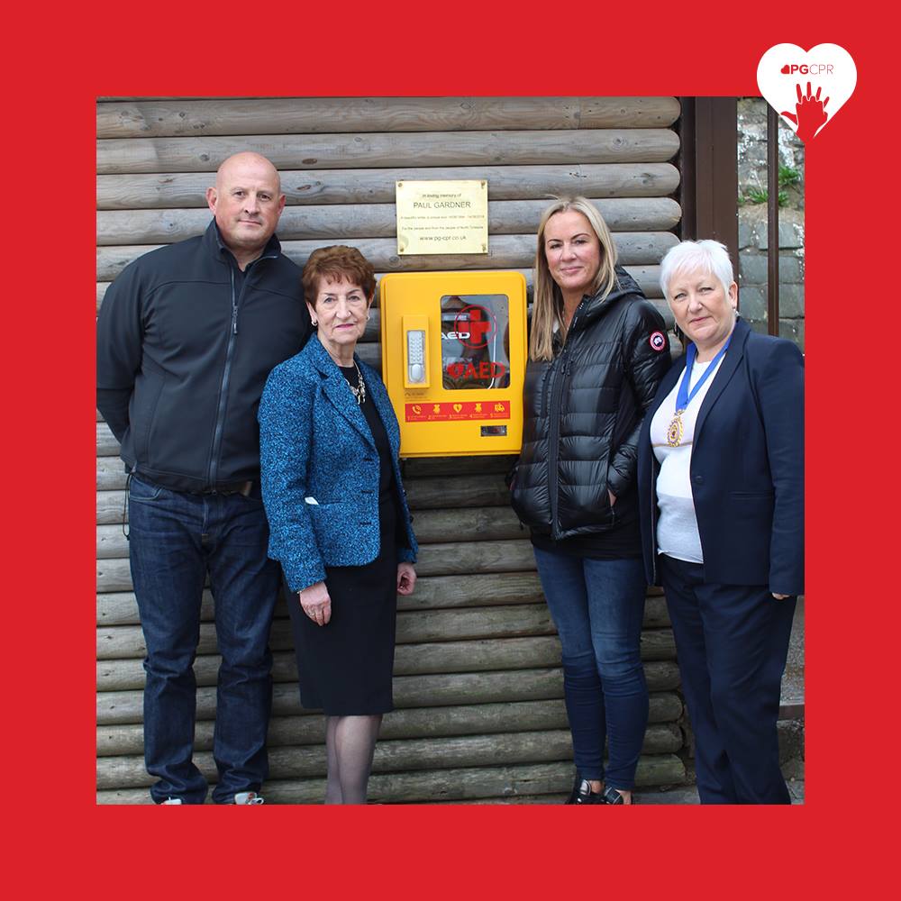PG_CPR's tweet photo. Pauls mum Carla and step dad Billy were joined by North Tyneside’s Elected Mayor Norma Redfearn CBE and Cllr Wendy Lott, Deputy Chairman of the council, Crusoe's cafe in Tynemouth to unveil one of the life saving defibrillators. @NTCouncilTeam #PGCPR ❤️ https://t.co/9pJl3bDiEo