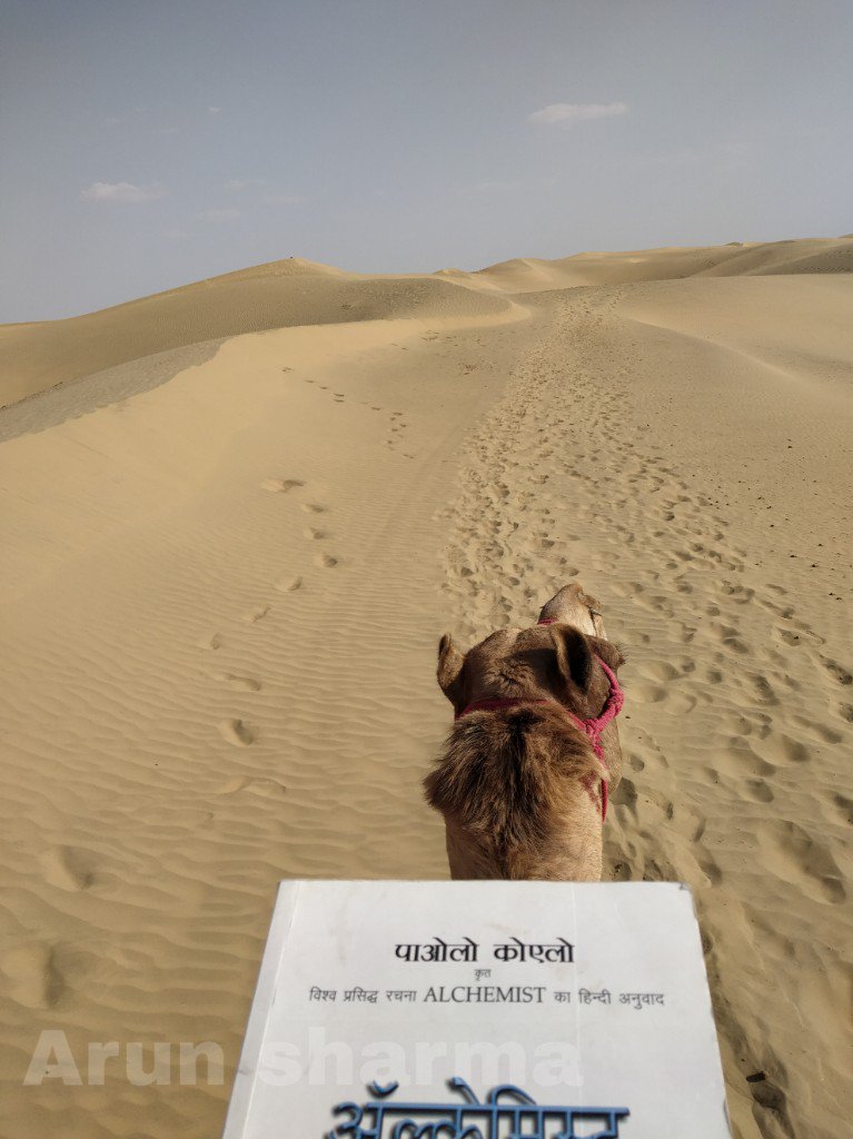arun__44's tweet photo. "The boy and his heart had become friends, and neither was capable now of betraying the other"
 
I've read this book so many times before,but reading @paulocoelho 's alchemist's hindi translation in a desert on a Camel is the best feel.
Even more determined to chase my dreams..! https://t.co/EpMceI4Kcr
