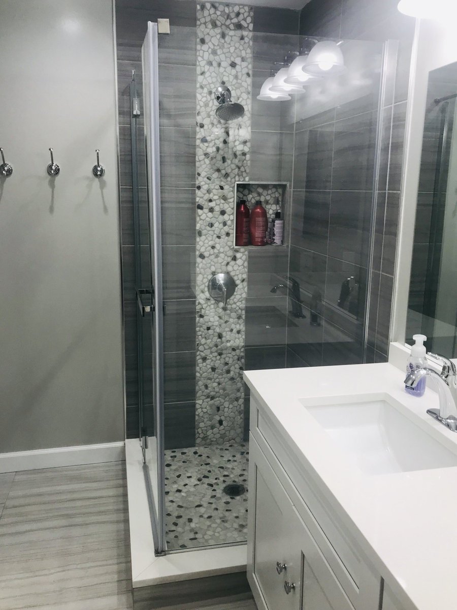 TechnicalDCC's tweet photo. New modern shower with pebble stone on accent and floor along with MS international Sophia gray tile! Limited space for Niche installation problem has been solve aesthetically with creativity. #bathroomlove #Design #TechnicalDCC https://t.co/wjoUC3yRZ4
