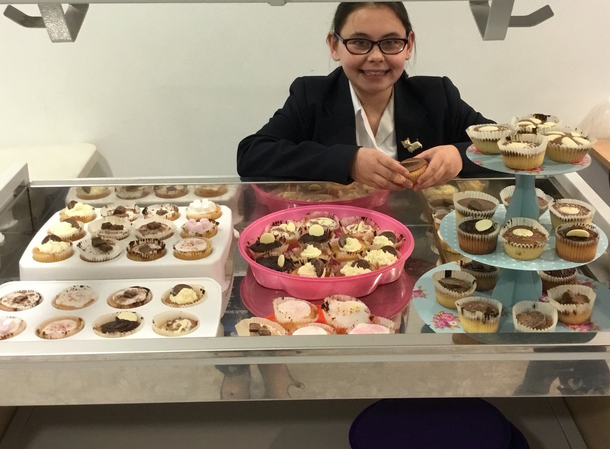 Well done to Year 7 Alana Faulkner, who has taken it upon herself to raise money for Cancer Research UK, by running a series of cake sales. This is Alana with the 72 cakes she baked and iced herself last night and sold in school today. They were delicious!