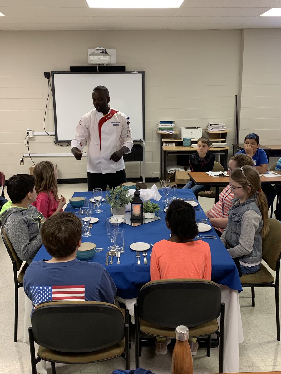 cville_schools's tweet photo. Executive Chef @ChefUlysse Charles took time this morning to teach fine dining etiquette to aspiring chefs at Tara Oaks Elementary School. @sodexoUSA https://t.co/IV2mbWrFcY