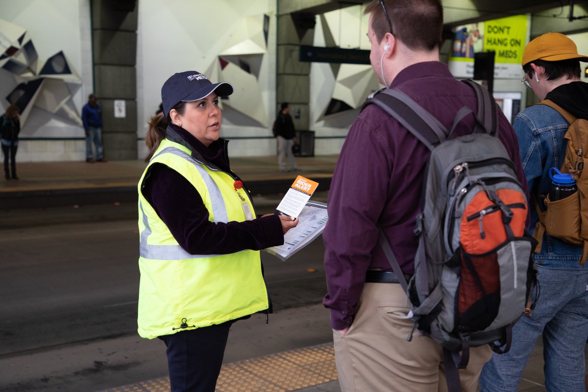 Metro's Penny Lara speaks with a bus riders about changes at International District Station