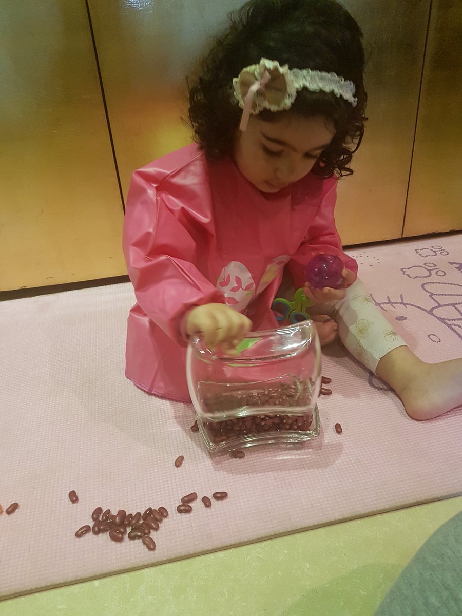 Transferring beans..tried the tweezer...grabber..scooper and finally chose the short cut... #toddlers #finemotorskills #earlychildhood #playmatters #playbasedlearning #PlayfulParenting