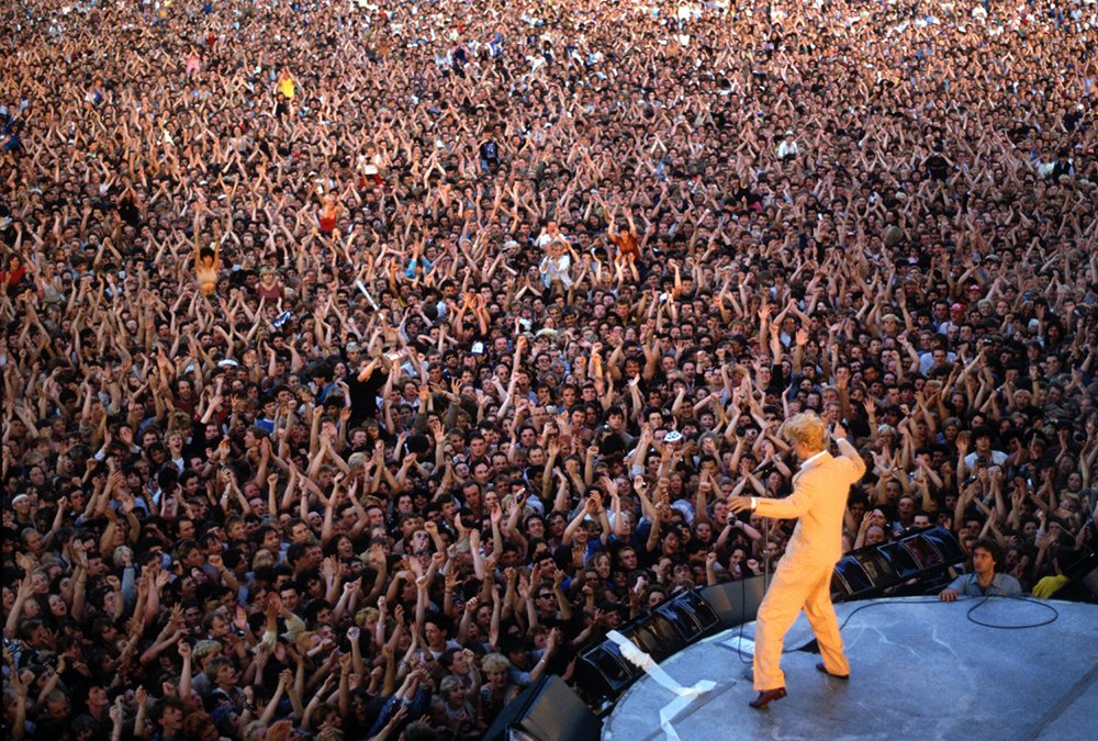 bowie1983book's tweet photo. Denis captures the charisma of #DavidBowie &amp; his incredible onstage presence, only enhanced by the 300k people surrounding him. The tour was originally intended to play smaller venues, but the success of #LetsDance catapulted the tour into the stratosphere.

@TheDenisORegan https://t.co/jexoeMQpmF