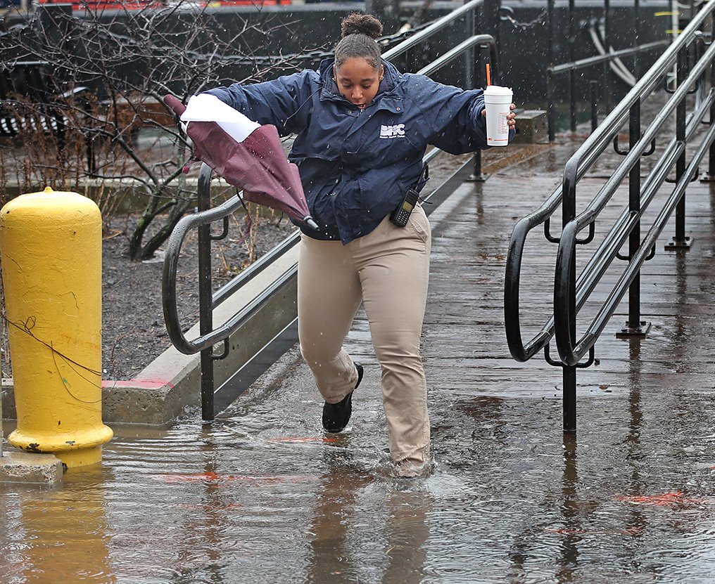 FLOODING...always seems to be that one place for high tide obstacle like here on Long Wharf Boston....Patrick Ronca goes over with long legs and hand railings. Rian Dalton...just run through it ! Keep the coffee dry but wet feet for Glenda Winslow.