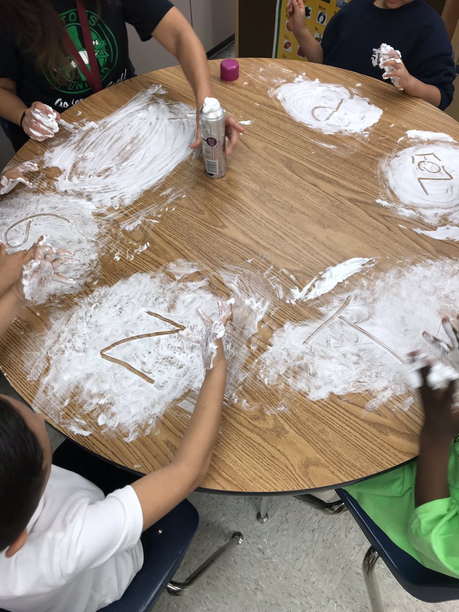 Practicing letters in shaving cream.