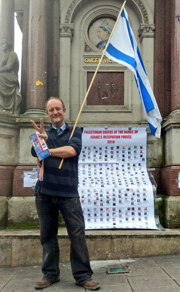 Supporter of @SussexFriends of Israel deliberately and "proudly" standing in front of poster of Palestinians killed by Israel