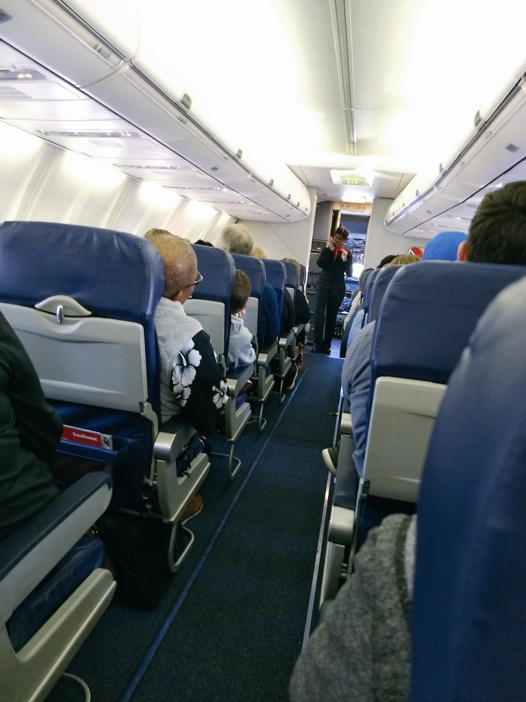 SarahAminNC's tweet photo. This @SouthwestAir flight attendant is amazing. We're not even off the ground and we're getting first class treatment. She should get a raise or bonus or something. #flyingisfun #namethatband #snacksforeveryone https://t.co/S04naqFNc0