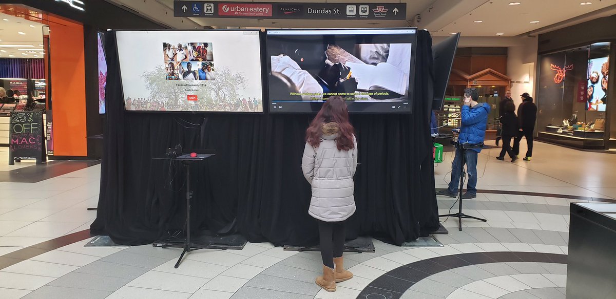 redcrosscanada's tweet photo. Visitors to the Eaton Centre in Toronto are meeting the #FacesOfHumanity today. This interactive exhibit shares the stories of people who have been impacted by “silent emergencies” around the world. #redcross #humanitarian https://t.co/J62eTPKufg