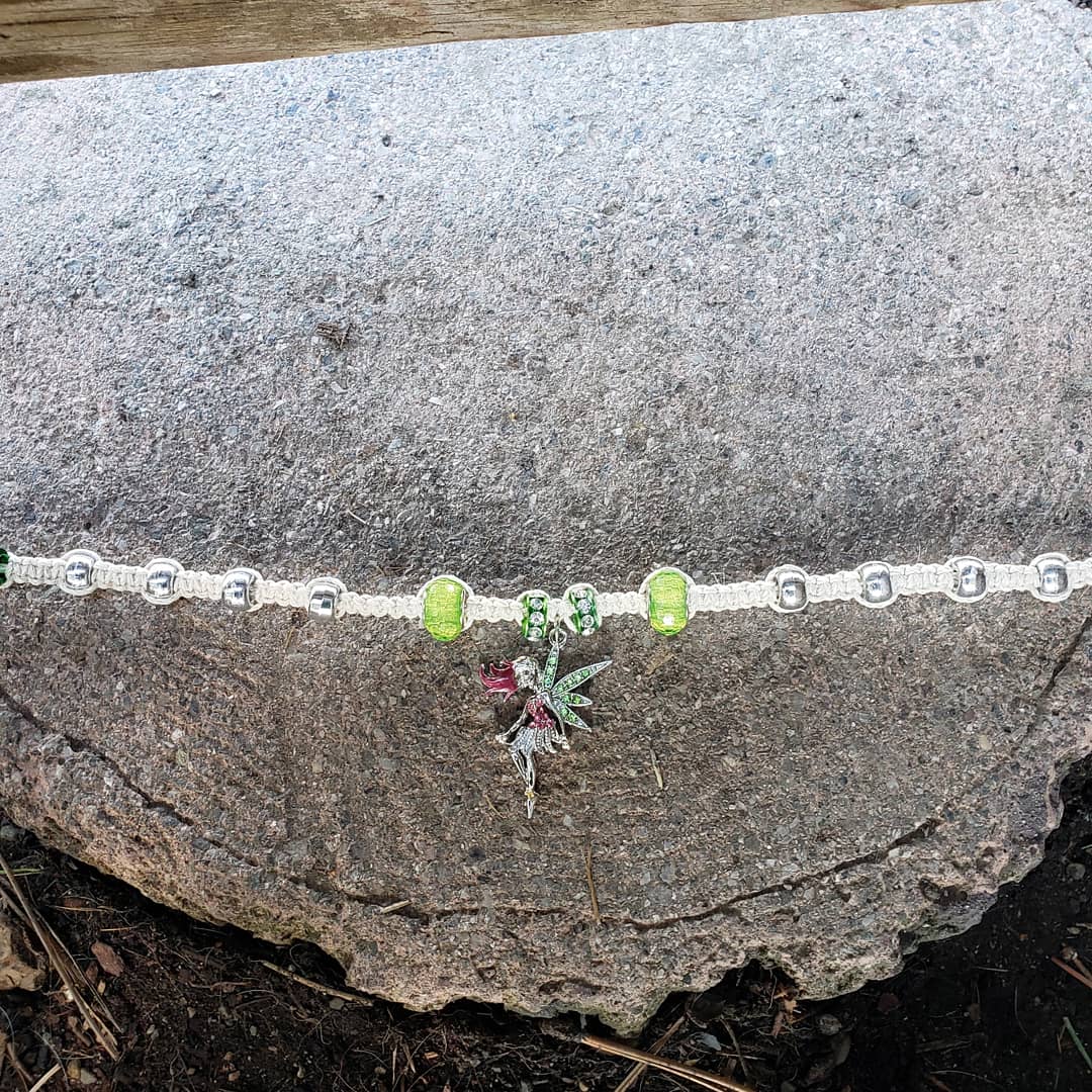 Fly into spring with this fierce and graceful fairy choker | #buttermilk #tan #hempcord #hemptique #metallic #green #silver #ponybeads #accentbeads #fairypendant #hempchoker #statementnecklace #handmade #macrame #squareknots #knotty_introvert_creations