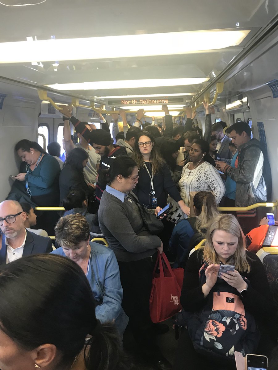 NormanHermant's tweet photo. Sorry #Comeng fans. These are woeful in peak. 3 x 2 seats means very little standing room. Lack of overhead grab bars means middle standers have to reach for a rare seat back handle. They’re just not good mass people movers @metrotrains. @ptua https://t.co/8lTEMimF9i
