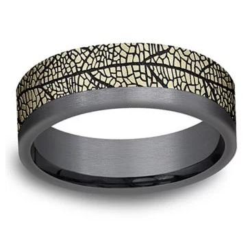 D_CJeweler's tweet photo. The combination of tantalum and the yellow gold leaf design give a very organic look.  This band comes in 1/2 sizes from 7 to 12. Click here to order https://t.co/vFsqNPxkKM #DCopperFieldJeweler #PriorLakeMN #Jewelry https://t.co/TZpQY9sQmE