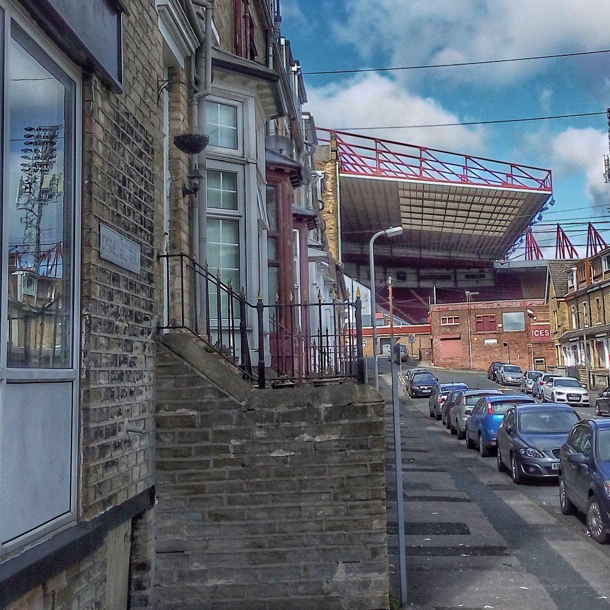 absurdlyso's tweet photo. floodlight spotted in the window #surrealismonthestreets a glimpse of valley parade #bradfordcity #BCAFC as I wander round Manningham #bradford #reflection #surreal #streetsofbradford https://t.co/U7vtvyttkB