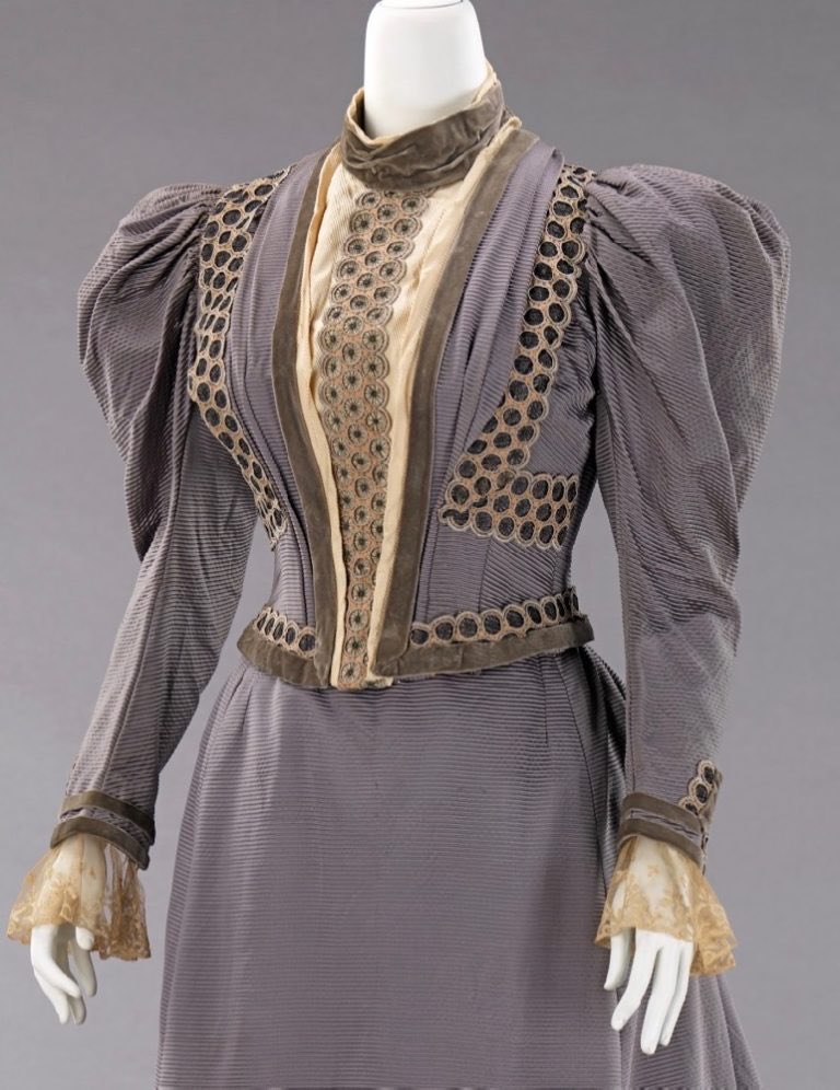 Fine striped figured silk in lavender grey is trimmed with sage velvet and a waterfall of tiny cartwheels, like hand strung Dorset buttons that cascade down the centre front of the bodice, 1893 #weddingdress <a href="/metmuseum/">The Metropolitan Museum of Art</a> #fashionhistory