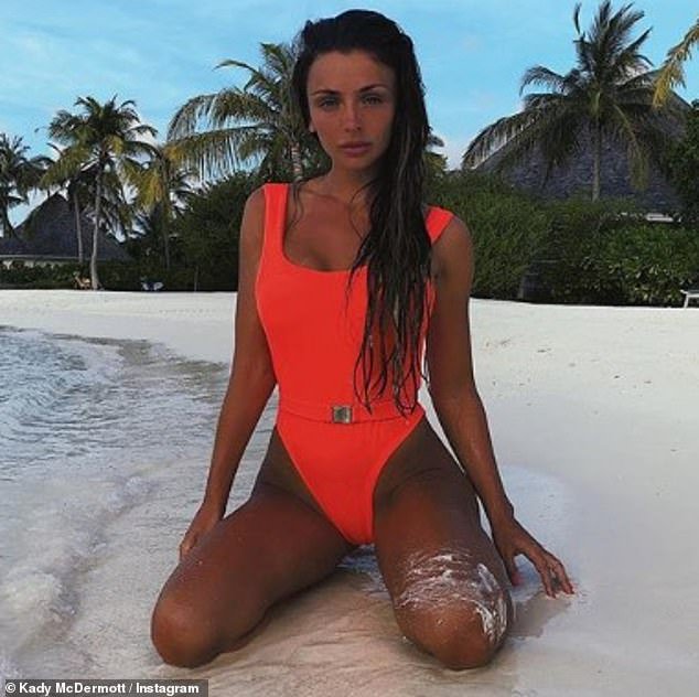 Kady McDermott poses in a neon orange swimsuit and a black bikini in the Ma...