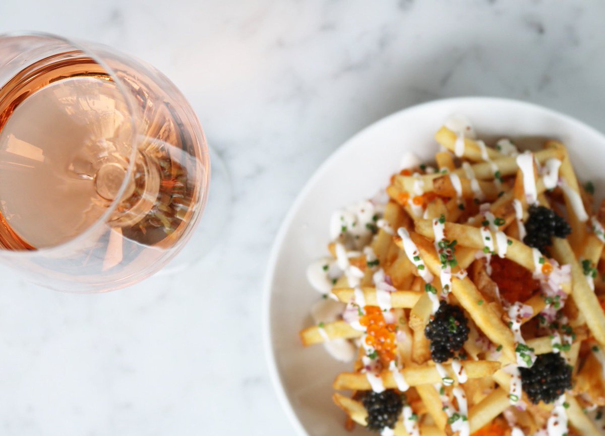 Our personal favorite pairing is a glass of wine and Caviar Frites.