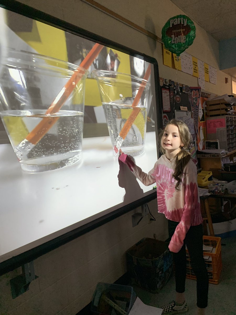 Fifth graders learning about refraction of light.