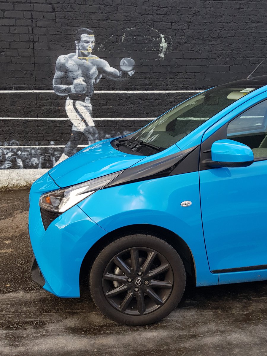 CarReviewUK's tweet photo. Just the ideal car for seeking out Liverpool's street art - The Greatest would have been proud of this wall mural. #Aygo
 https://t.co/OsoUCAHubZ 
@ToyotaPR @ToyotaUK @NGMWcars https://t.co/HQu0lfjURB