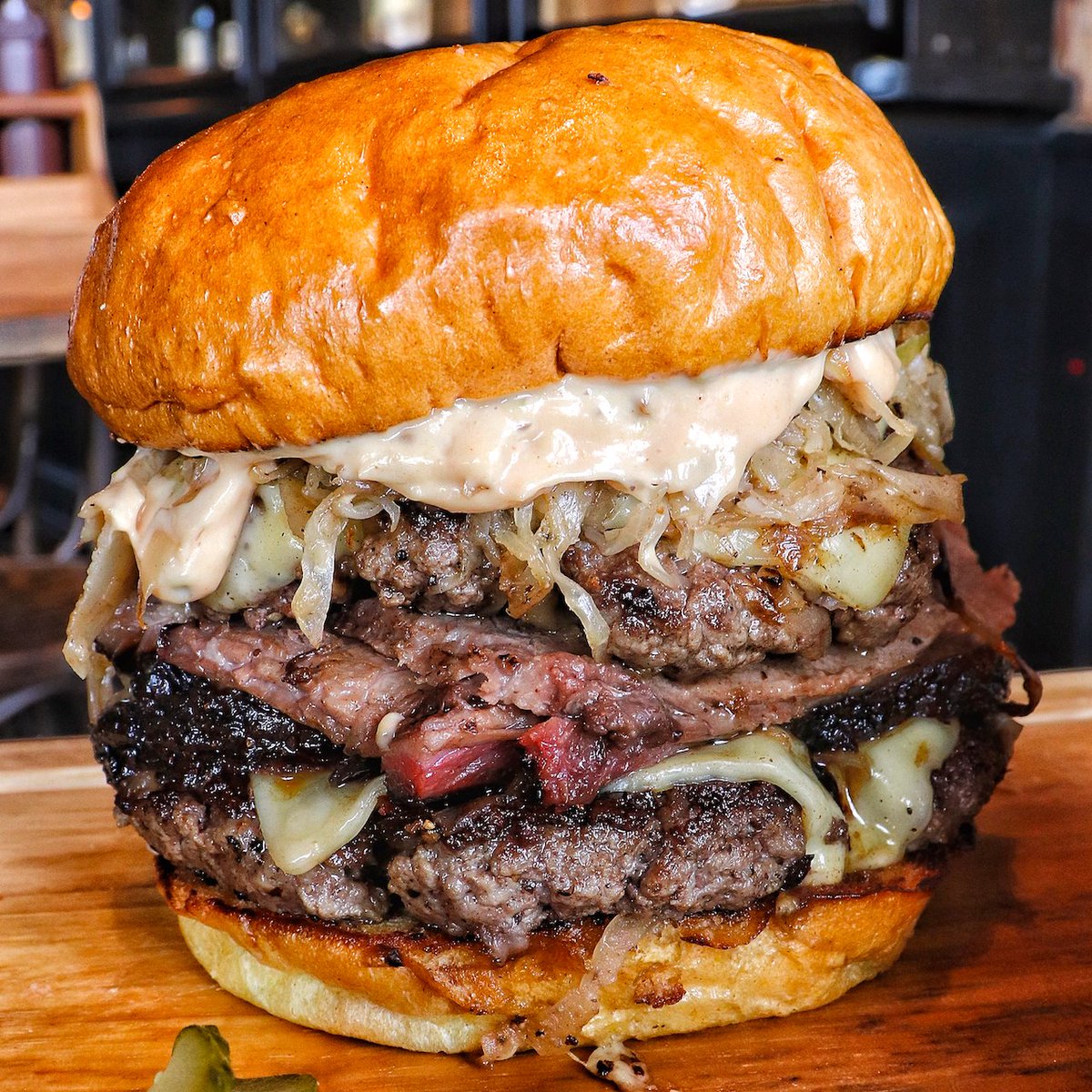 Beat the mid-week blues with a Red Dog Reuben. It features thick Chuck steak patties, mounds of our hickory smoked brisket, sauerkraut, Swiss cheese &amp; Russian dressing. #NoNeedToTravelToMoscow