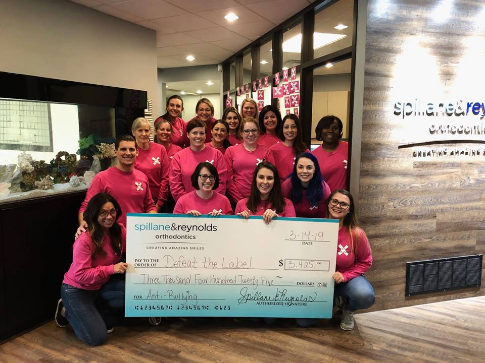 DrJamieReynolds's tweet photo. In Feb, our office at @SpillaneReynold decided to partner with @DefeatTheLabel to raise $ that will go towards sponsoring a local school's anti-bullying classes. Thanks to everyone who made this possible! ππΌ #orthodontics #orthodontist #antibullying #defeatthelabel #oralhealth https://t.co/HNUldn8I55