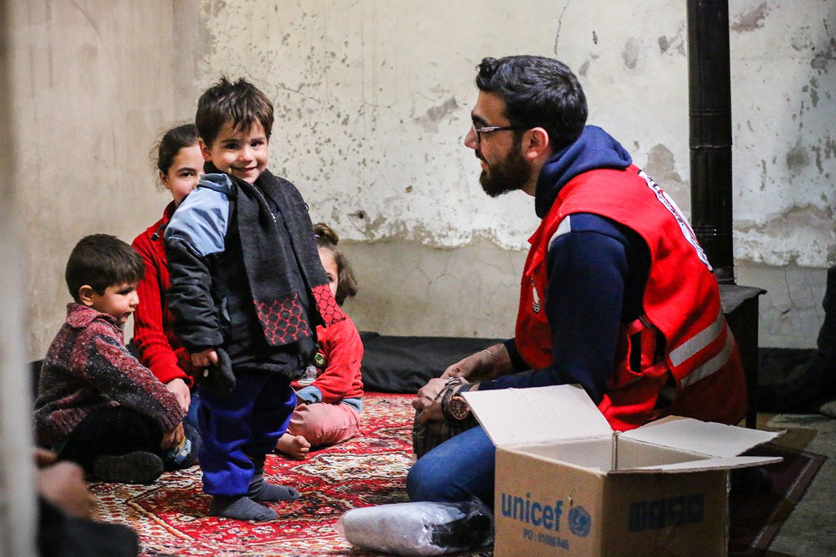 SYRedCrescent's tweet photo. #Happiness glitters clear in the eyes of the #child who hasn't articulated his first words yet 
@SYRedCrescent distributed #winter clothes, provided by @UNICEF, in #RuralDamascus. https://t.co/Sehry0Dk9M