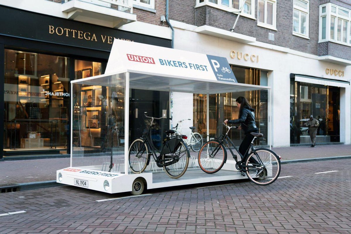 devonzuegel's tweet photo. This mobile parklet fits 8 bikes. With a license plate, it can be legally parked anywhere for the price of parking 1 car. Genius. https://t.co/cFshYA4C1N https://t.co/p6xTfLd5CA