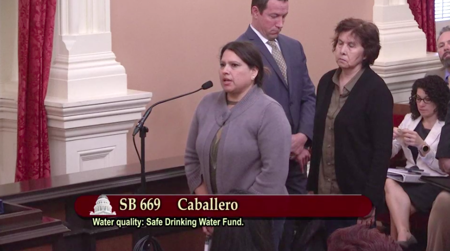 CWaterC's tweet photo. "I'm here to oppose [SB 669] in honor of the 30 homes left behind in West Goshen on private wells who need a safe drinking water solution" - Lucy Hernandez, activist with AGUA Coalition and resident of West Goshen #NoToxicTaps https://t.co/79A5ounIxR