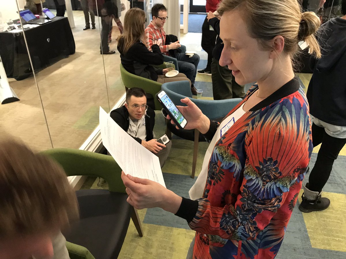 Attendees at a Tech 4 Housing happy hour calling or writing their State Senator to support HB 1923, which encourages cities to expand housing options.