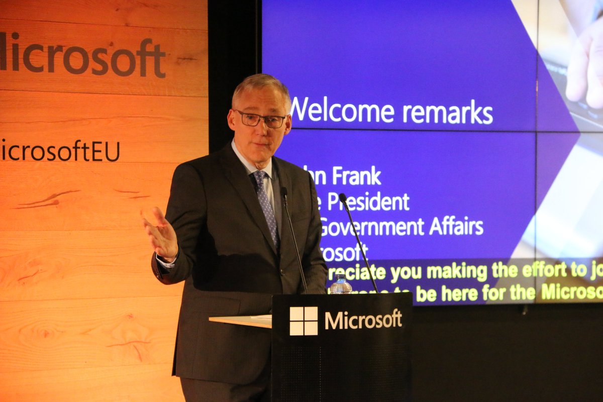 John Frank speaking on stage