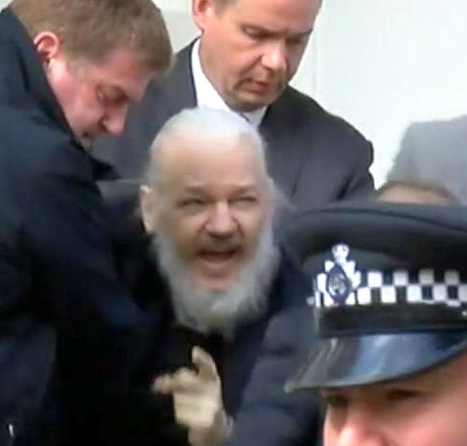 Assange being grabbed and arrested from  the Ecuadorian Embassy by London police