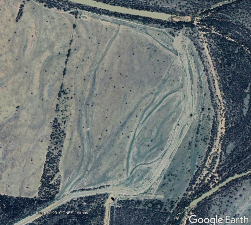 2. There is a long channel across the floodplain backed by a downstream levee, to divert 'overland flow' to a natural ox-bow lake ('billabong') that has been converted to form a large water storage. Note the river overflow paths across the floodplain.