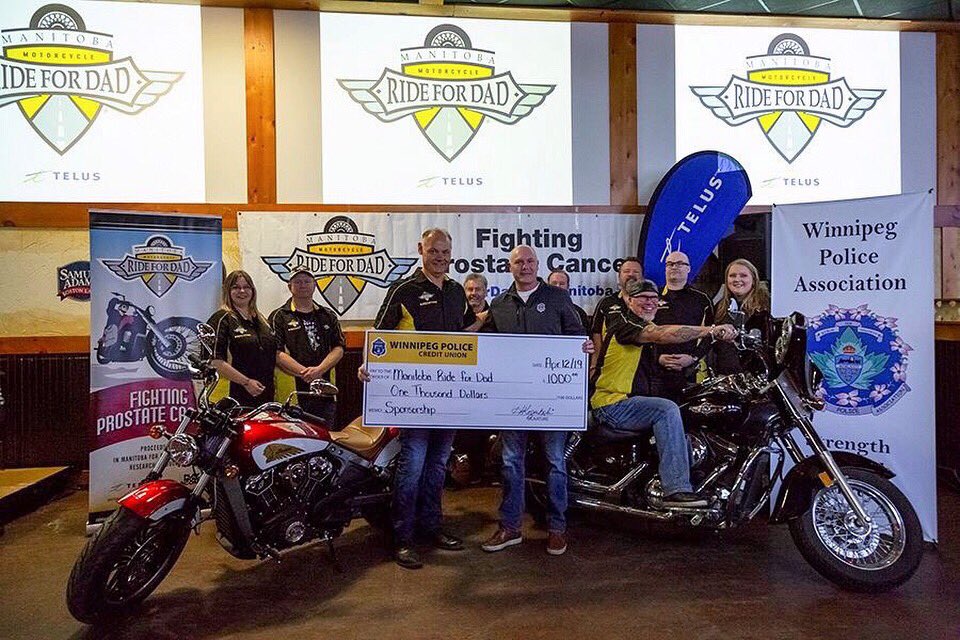 WPCU’s CEO Cal Berzuk presents co-chair Moe Sabourin with a sponsorship cheque for the Manitoba Ride for Dad.  10 WPCU staff members volunteer their time to help with registration for the event.