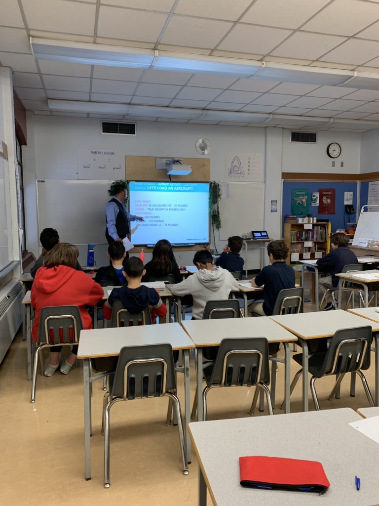 LangevinSchool's tweet photo. Craig is speaking to the kids about the importance of math in loading airline cargo #cbe #stem #steam #cbeSTEM #weareCBE #langevinscience #divison2steamcareerfair https://t.co/NFVOQlTcv1