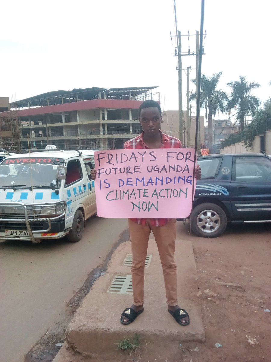 Fridays4FutureU's tweet photo. 17 year old #climatechange striker and one of our mobilizers @matovu_bob has braved the hot sun to send his message to the public and leaders. "Fridays For Future Uganda is demanding #ClimateAction now. @GretaThunberg @Greenpeace @Fridays4future #schoolstrike4climate https://t.co/eeYrbWyBKx