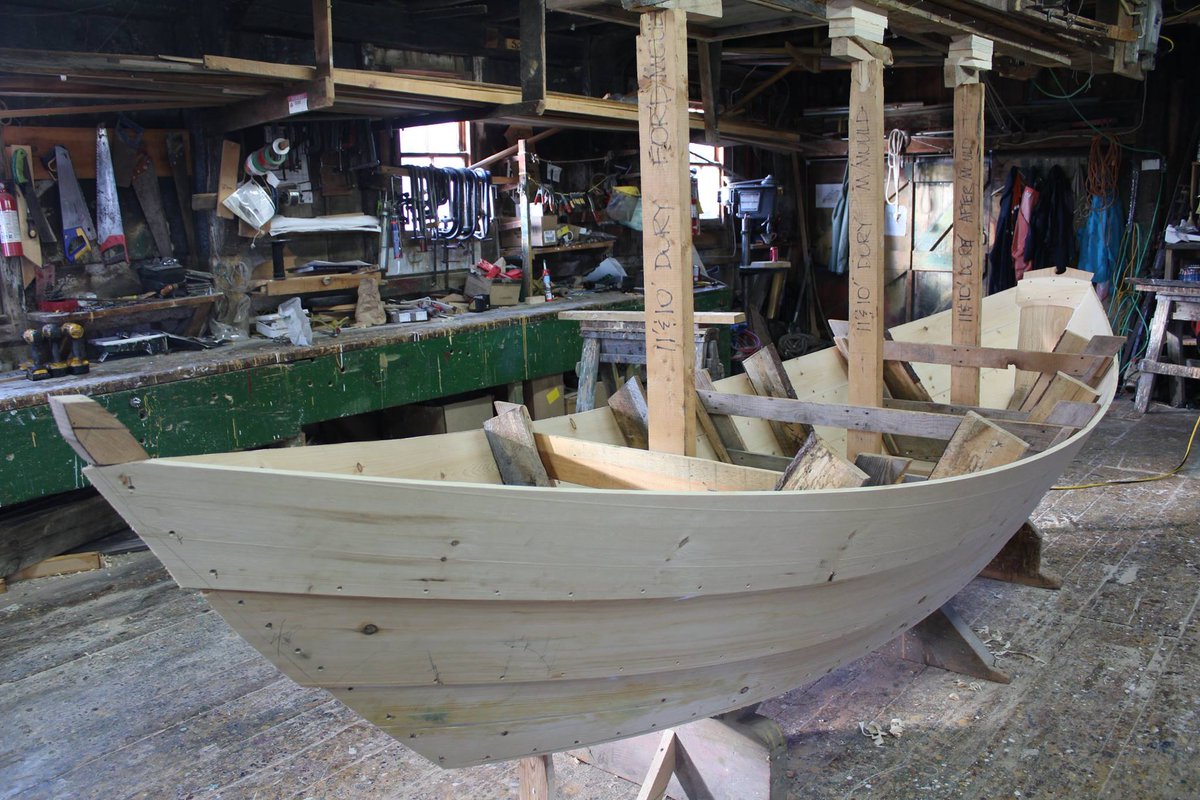 DoryShop's tweet photo. The building of a dory in 10 days - end of day 5, sheer plank in place; planking is done. Rough knees in place. #dory #doryboat #woodenboat #buildingaboat #Lunenburg #day5 #knees #planked https://t.co/iLnPzcbzSk