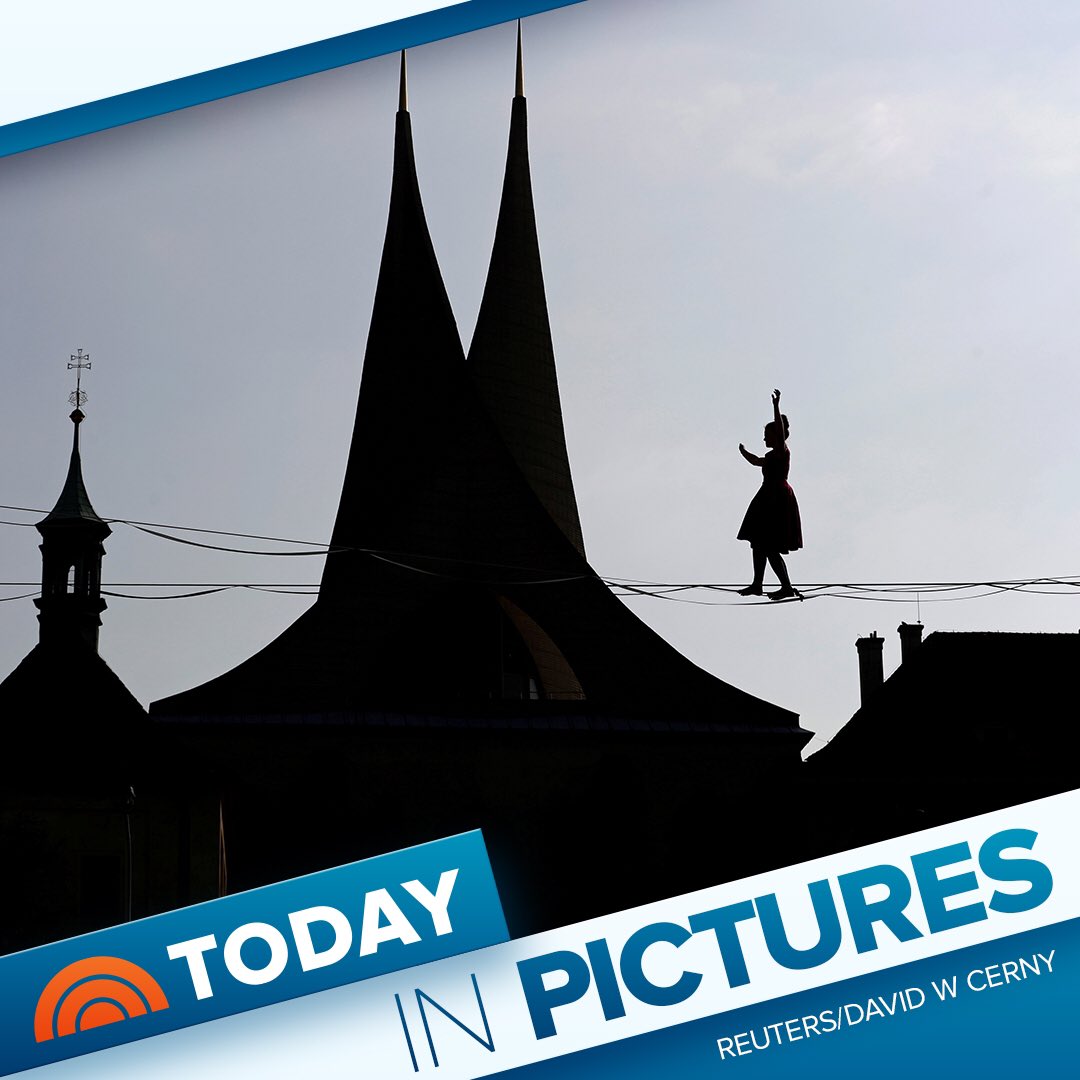 TODAYGraphics's tweet image. A tightrope walker performs on ropes stretched over the Emmaus Monastery in Prague, Czech Republic.