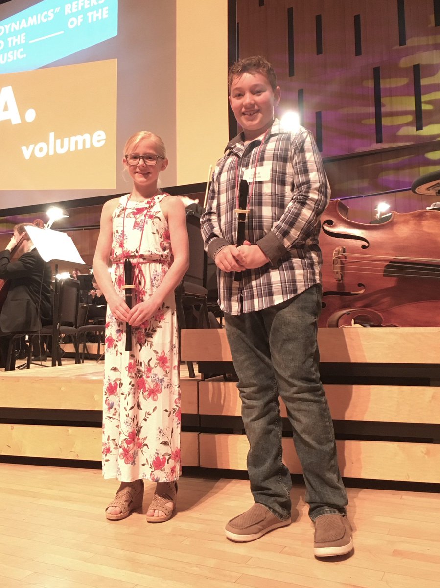 Ally and Taiden from 4R are ready to perform on stage at the symphony while their classmates wait for the performance to start.