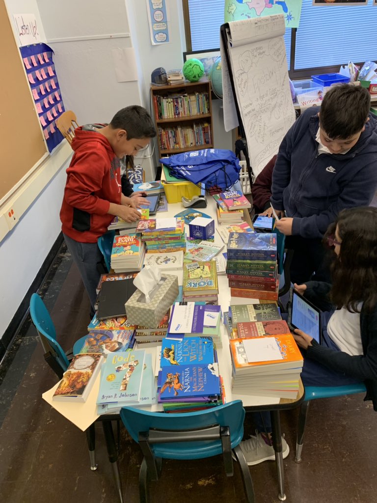 Mrs_Patterson5's tweet photo. Sorting the books they received from #KPMG by recording reading levels/utilizing the data from their school survey in order to properly deliver these goodies to @RoySchoolBulls classrooms! https://t.co/6uQbPcXC6h