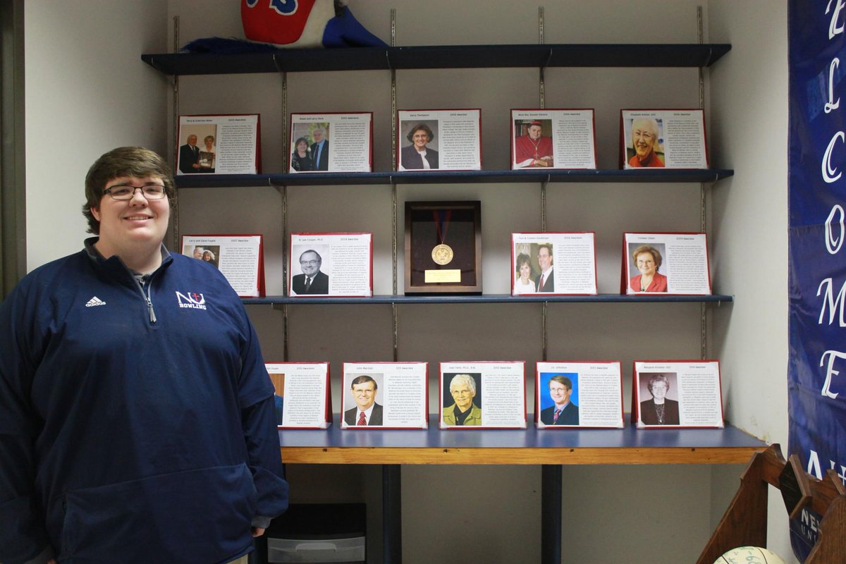 NewmanU's tweet image. Student Michael VanDeest took on the massive project of researching all past Cardinal Newman Medal awardees. His work is on display in the Heritage Room and Archives in Sacred Heart. #NewmanU #History #Archives #Project