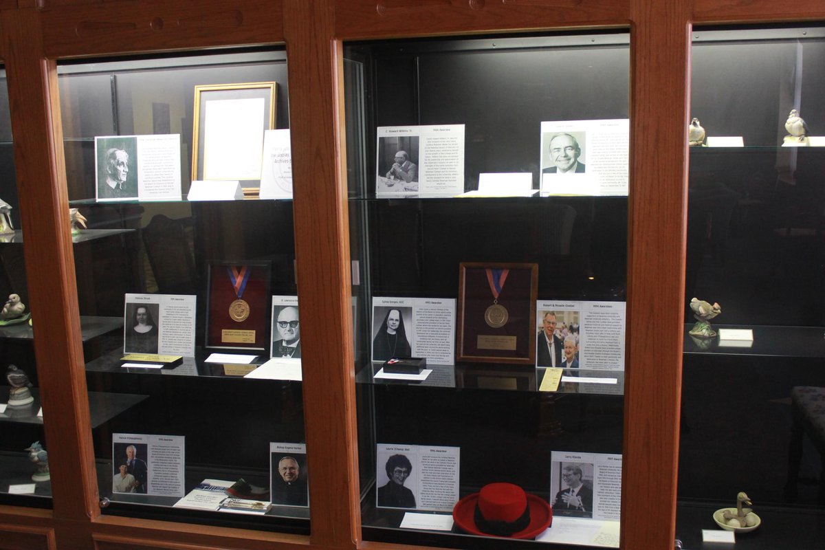 NewmanU's tweet image. Student Michael VanDeest took on the massive project of researching all past Cardinal Newman Medal awardees. His work is on display in the Heritage Room and Archives in Sacred Heart. #NewmanU #History #Archives #Project