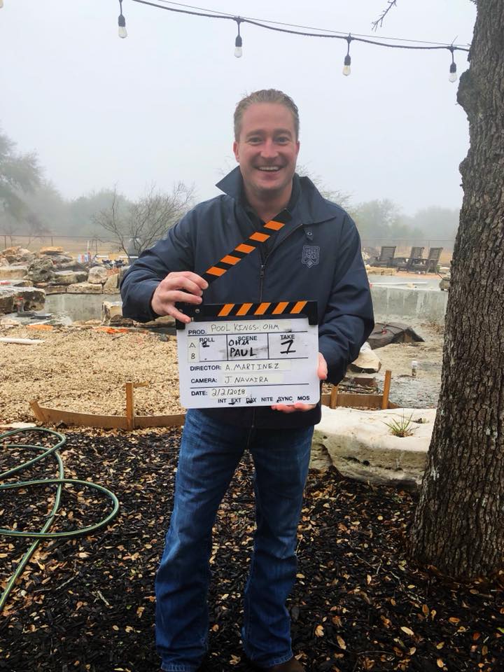 EditorManCaves's tweet image. Here's a great look behind the scenes on one of our pools. Paul here holding the clap slate with a totally mid way finished pool in the back. You can see boulders for the waterfall, forms on the ground to pour decking. It's great. #HomeImporvement #PoolKings