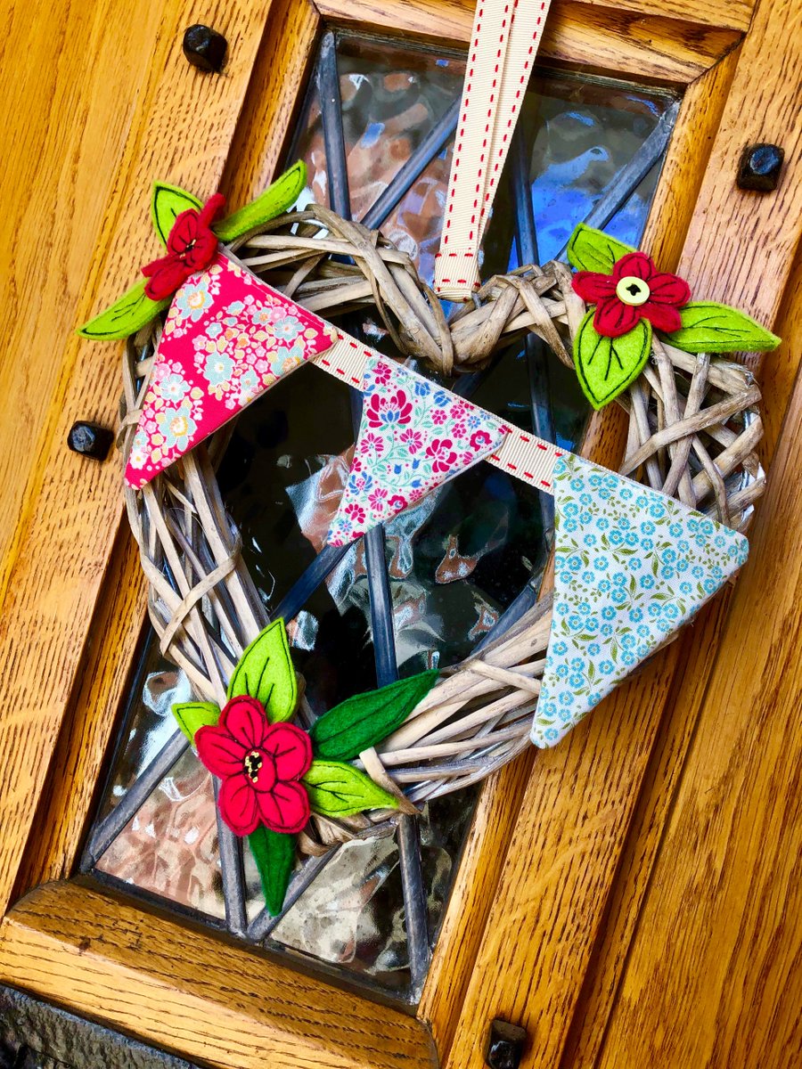 2Beechhill's tweet photo. Lovely feature for a front door to brighten up Spring. Felt flowers and  foilage all handmade as is the bunting. No more boring front doors ! https://t.co/FbG1UWa8vc